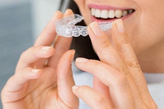 woman holiding invisalign aligner consumable