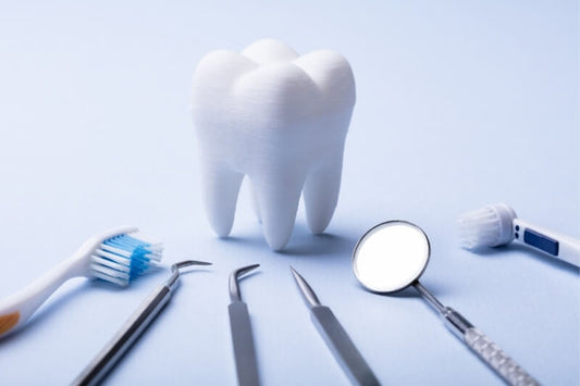 white tooth surrounded by different dental consumables